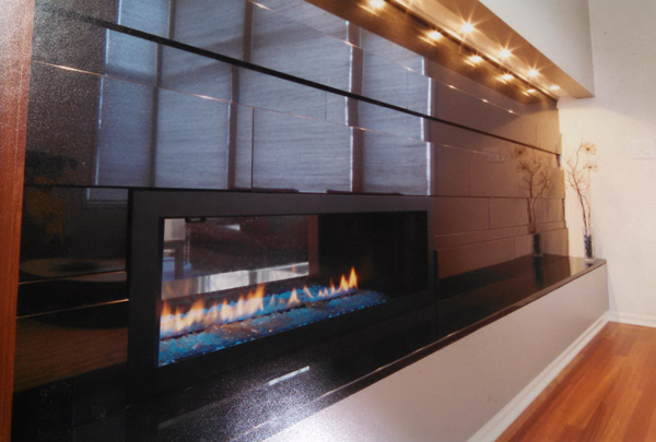 The fireplace wall (also viewable from the kitchen) is faced with gunmetal iridescent handmade tile made by Heath Ceramics, a women-owned firm that specializes in mid-century modern glazes