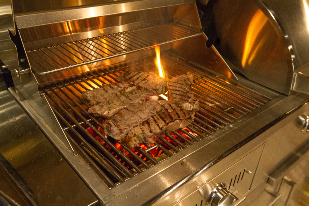 Steaks cooking on grill