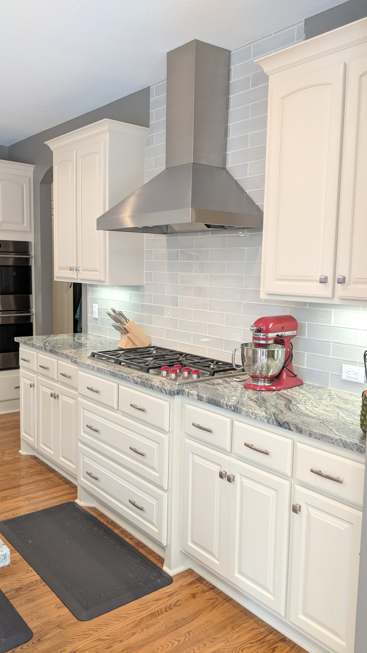 After - kitchen range wall new Granite tops  W/ glass subway tile