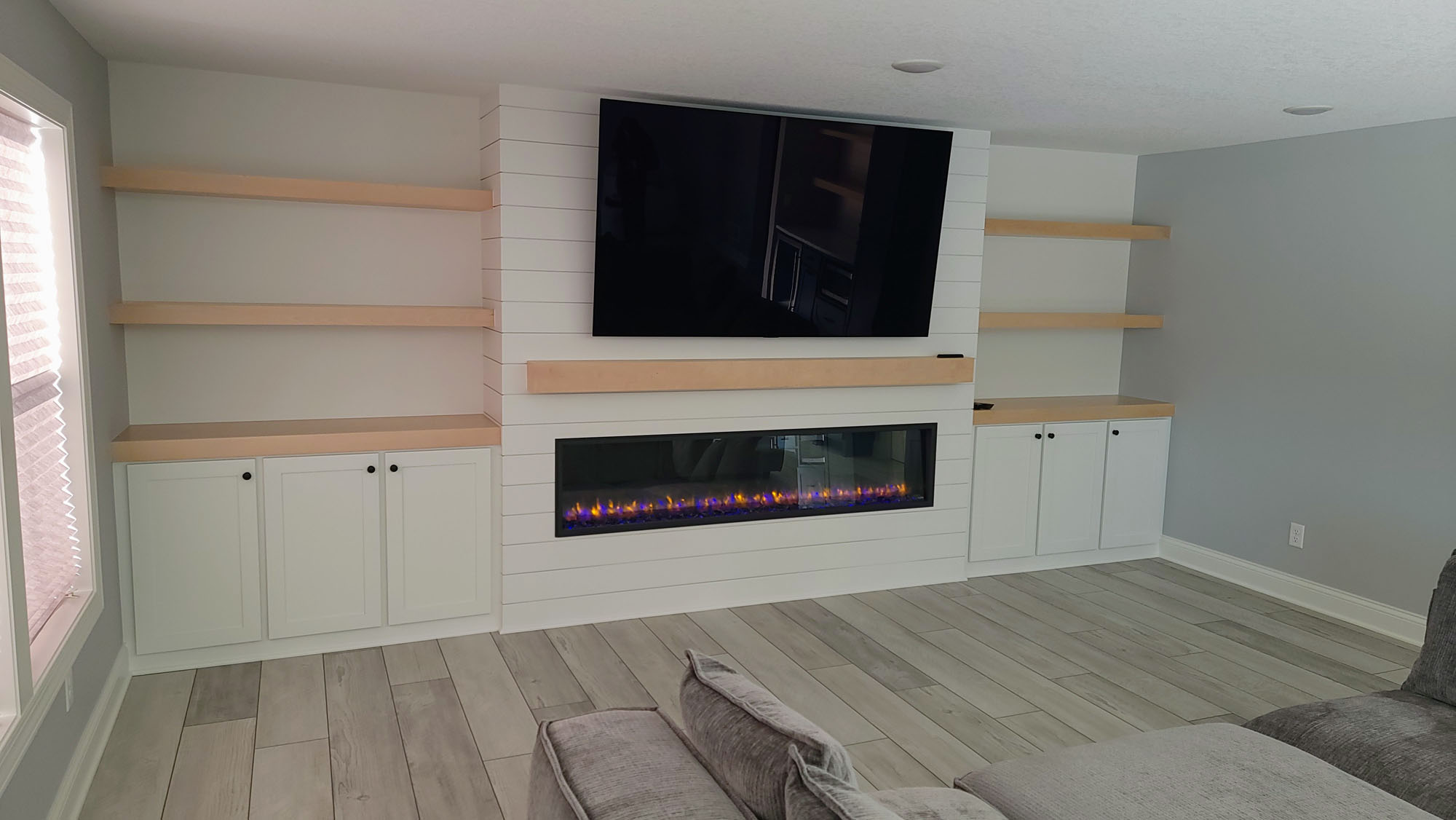 74″ TV w/ Natural Birch wood mantle and floating shelves