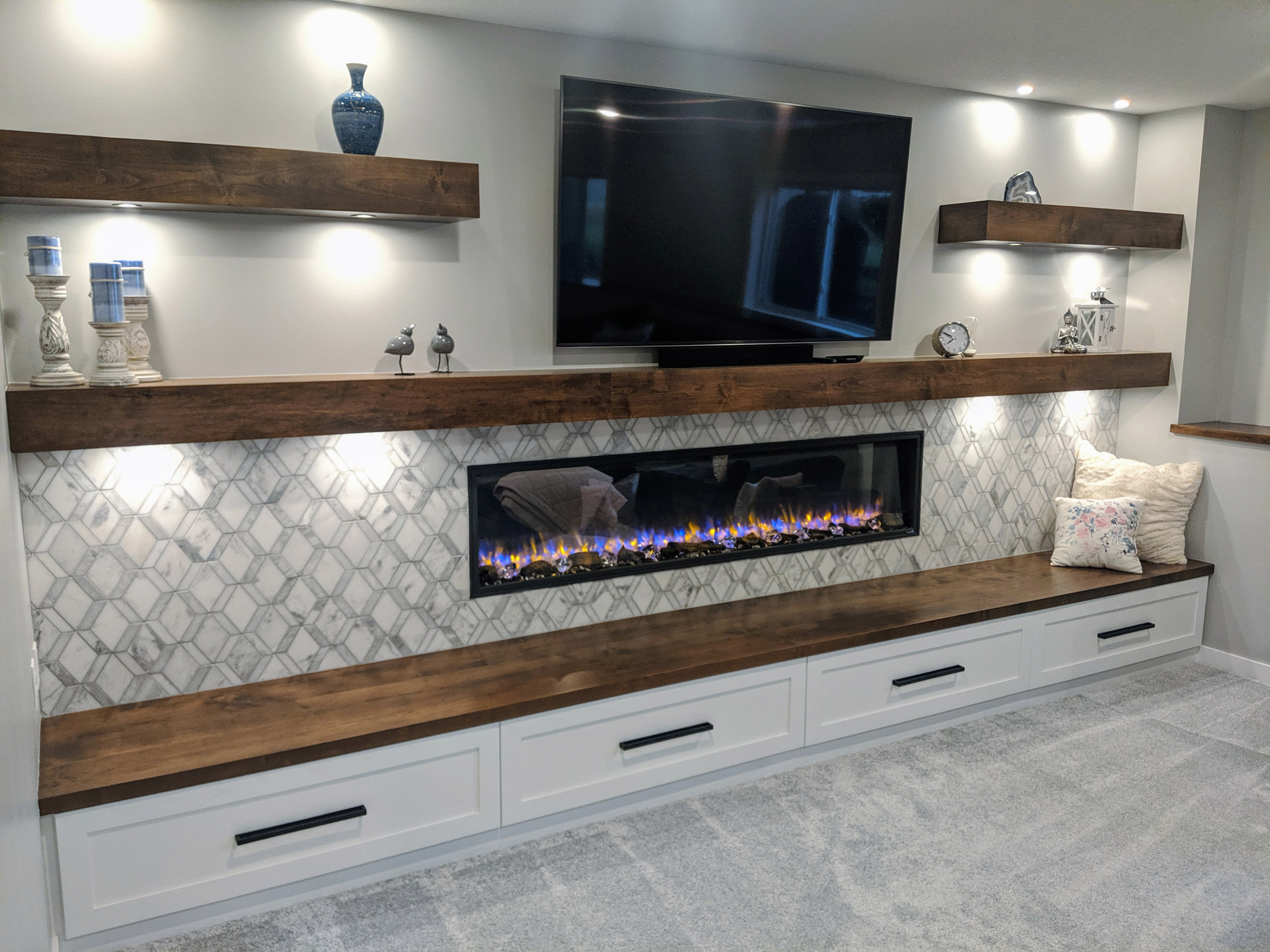 Media wall boasts a 78″ electric Fireplace, 65″ TV
