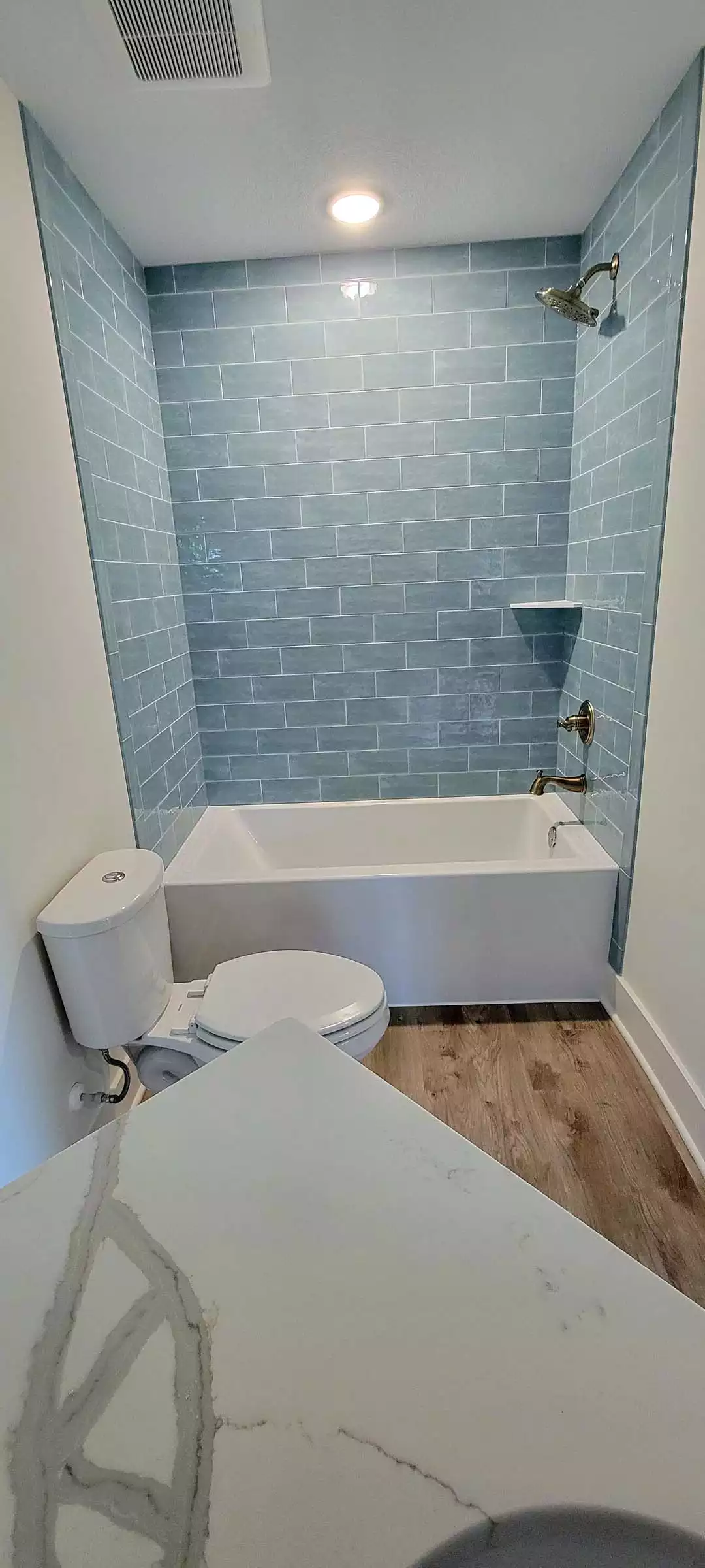 Full Bath with blue tile shower