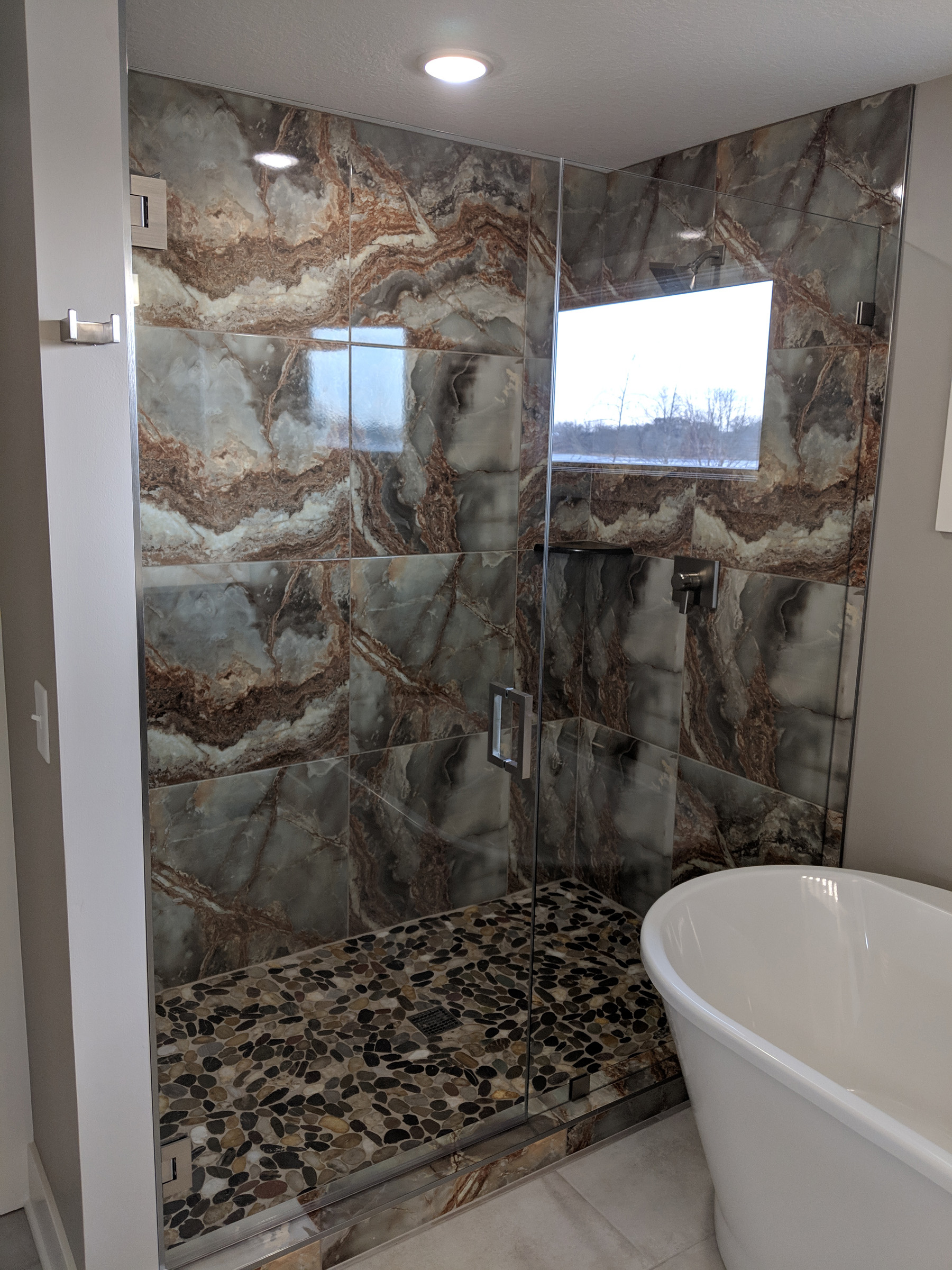 Stunning stone and tile shower with glass door